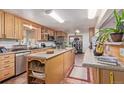 Bright kitchen with an island, granite countertops, stainless steel appliances, and tile flooring at 9400 W Burgundy Ave, Littleton, CO 80123