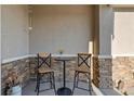 Inviting covered patio featuring modern outdoor seating and stone accents for relaxing and entertaining at 16482 Ledyard S Rd, Platteville, CO 80651