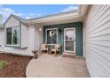 Inviting front porch with rocking chairs and a view of the neighborhood from this lovely home at 5408 E Briarwood Cir, Centennial, CO 80122