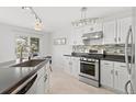 Updated kitchen featuring stainless steel appliances, white cabinets, and a stylish backsplash at 2545 Andrew Dr, Superior, CO 80027