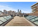 City skyline view from a spacious rooftop deck with skylights and outdoor seating area at 1449 Wynkoop St # 601, Denver, CO 80202