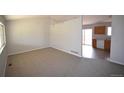 Open-concept living room with new carpet and views into kitchen area at 2685 W Asbury Ave, Denver, CO 80219