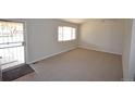 Bright living room featuring new carpet and ample natural light at 2685 W Asbury Ave, Denver, CO 80219
