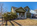 Charming two-story home featuring a well-manicured lawn and an attached two-car garage at 11405 Iola St, Commerce City, CO 80640