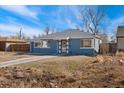 Charming blue home with manicured lawn, complemented by mature trees and a serene neighborhood setting at 2930 Oneida St, Denver, CO 80207