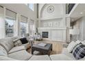 Open living room features a fireplace, large windows, and comfortable seating at 12110 Bay Oaks Ct, Parker, CO 80138