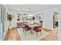 Bright dining room featuring a stylish chandelier, modern art, and a dining table with seating for six at 10016 Teton Ct, Lone Tree, CO 80124
