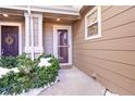 Townhome entrance with storm door and landscaping at 17359 Waterhouse Cir # C, Parker, CO 80134