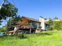 This exterior elevation shows the home's deck and back of home at 1151 Castlewood Pl, Franktown, CO 80116