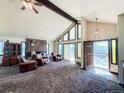 Spacious living room with vaulted ceiling and large windows for plenty of natural light at 1151 Castlewood Pl, Franktown, CO 80116