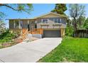 Charming split-level home featuring a newly built deck and attached two-car garage at 7448 W Geddes Pl, Littleton, CO 80128