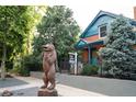 Exterior image featuring a wooden bear statue and a real estate sign in front of the home at 2445 W 39Th Ave, Denver, CO 80211