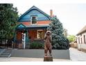 Charming red brick home with a bear statue in front and a real estate sign in the yard at 2445 W 39Th Ave, Denver, CO 80211