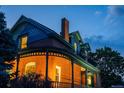 A beautiful red brick home exterior featuring detailed architecture, arched windows, and a classic chimney at 2445 W 39Th Ave, Denver, CO 80211