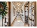 Inviting hallway featuring a brick barrel ceiling, wood floors, and ample natural light at 9435 Winding Hill Way, Lone Tree, CO 80124
