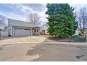 View of the property with a driveway and well-manicured front yard landscaping at 1834 Hennington Ct, Longmont, CO 80501