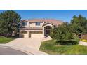 Charming two-story home boasting a three-car garage and landscaped front yard at 10085 Charissglen Ct, Highlands Ranch, CO 80126