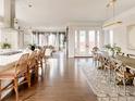 Open concept dining room with a large wooden table and seating for eight at 6003 Chester Way, Denver, CO 80238