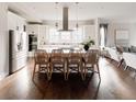 Modern kitchen featuring white cabinetry, a large island, and stainless steel appliances at 6003 Chester Way, Denver, CO 80238