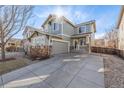 Charming two-story home featuring a covered porch, stone accents, neutral siding, and an extended driveway at 12133 Hannibal St, Commerce City, CO 80603