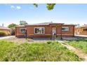 Quaint brick house featuring classic architecture, a covered entryway, and a mailbox by the sidewalk at 1560 Pueblo Ct, Thornton, CO 80229