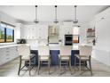 Modern kitchen island featuring white countertops, a navy blue base, and seating for four at 3343 S Newcombe St, Lakewood, CO 80227