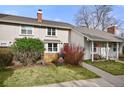 Charming two-story home with well-maintained lawn and mature landscaping at 6988 S Knolls Way, Centennial, CO 80122