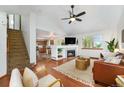 Spacious living room with a fireplace, open floor plan, hardwood floors, and easy access to the kitchen at 13504 Pecos St, Westminster, CO 80234