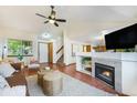 Open living room featuring a fireplace, built-in shelving, hardwood floors, and plenty of natural light at 13504 Pecos St, Westminster, CO 80234