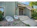 Inviting front door with outdoor seating, showcasing the home's charming entryway and landscaped surroundings at 19 Benthaven Pl, Boulder, CO 80305