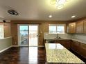 Spacious kitchen featuring a large island, hardwood floors, and a view of the backyard deck at 9377 Longstone Dr, Parker, CO 80134