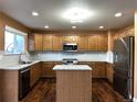 Modern kitchen boasts stainless steel appliances, granite countertops, and a functional center island at 9377 Longstone Dr, Parker, CO 80134