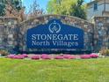 Stonegate North Villages entrance sign with colorful flowers and green grass at 9377 Longstone Dr, Parker, CO 80134