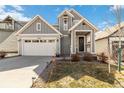 Charming two-story home featuring a well-manicured lawn, a cozy front porch and a two car garage at 27798 E 7Th Pl, Aurora, CO 80018