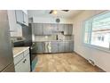 Updated kitchen featuring tile flooring, stainless steel appliances and abundant counter space at 2814 S Winona Ct, Denver, CO 80236