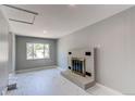 Spacious living room with marble floors, a grey brick fireplace, and a large window at 1170 Kingston St, Aurora, CO 80010