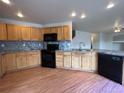 Spacious kitchen featuring wood cabinets and granite countertops at 20558 E Grand Ln, Aurora, CO 80015