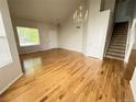 Spacious living area with gleaming hardwood floors, staircase and bright natural light at 20558 E Grand Ln, Aurora, CO 80015