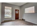 Bright living room with modern gray walls, laminate wood flooring, and ample natural light at 4514 Bryant St, Denver, CO 80211
