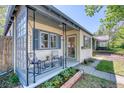 Exterior view of home showcasing cozy front porch with seating and curb appeal at 2684 S Logan St, Denver, CO 80210