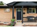 Inviting front entry with decorative door and black trim at 7256 S Broadway, Centennial, CO 80122