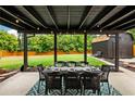 Inviting outdoor patio featuring a dining table set for eight, perfect for entertaining with views of the spacious backyard at 7256 S Broadway, Centennial, CO 80122