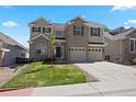 Attractive two-story home with a well-maintained lawn, three-car garage, and a welcoming brick facade at 22935 E River Chase Way, Parker, CO 80138