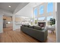 An open-concept living room featuring a fireplace and large windows that fill the space with natural light at 22935 E River Chase Way, Parker, CO 80138