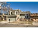 Charming two-story home showcasing a well-maintained lawn and a welcoming entrance at 7452 W Cedar Cir, Lakewood, CO 80226