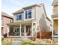 Charming two-story home with a welcoming front porch and beautifully landscaped front yard at 6764 Osage St, Denver, CO 80221