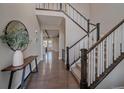 Grand foyer with an open staircase, hardwood floors and a modern table at 14589 Hagus Pl, Parker, CO 80134