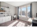 Bright bedroom with a large window, neutral carpet, and a built-in bookshelf at 16195 Red Bud Loop, Parker, CO 80134