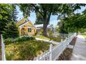 Beautiful home with a white picket fence and lush green lawn, perfect for outdoor enjoyment at 1776 S Logan St, Denver, CO 80210