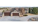 Spacious three-car garage, stone accents, and concrete driveway on a beautiful single Gathering home at 46692 Silver Fir St, Parker, CO 80138